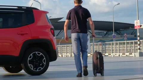 Young man packing a suitcase in the trunk of a car. Travel concept Video stock 159645696