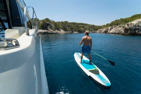 Young man on paddle board Stock Photos
