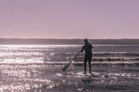 Young man paddle surfs the waves in majorca Stock Photos