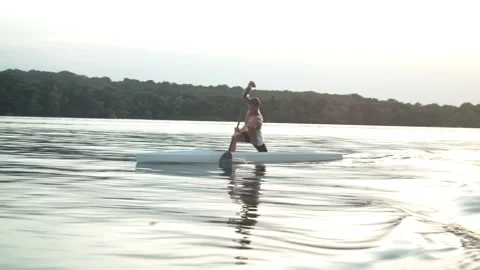 Young man paddling a canoe Stock Footage 135865262