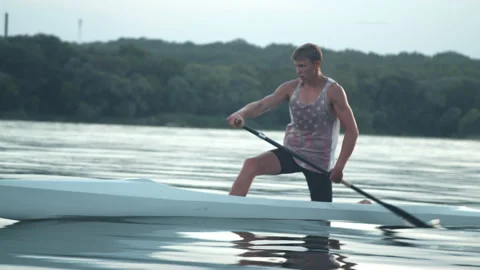 Young man paddling a canoe Stock Footage 135865454