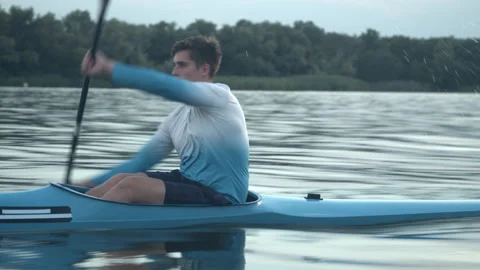 Young man paddling a kayak Stock Footage 135863901