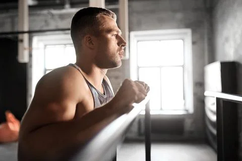 Young man at parallel bars in gym Stock Photos