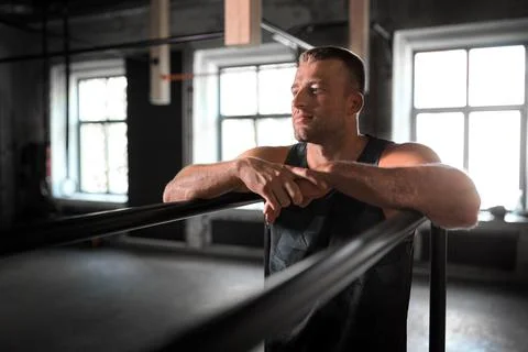 Young man at parallel bars in gym 写真素材