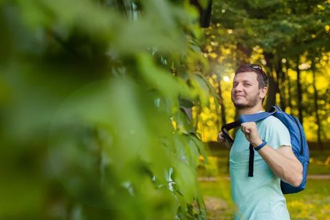 A young man in the park with a backpack Stock Photos