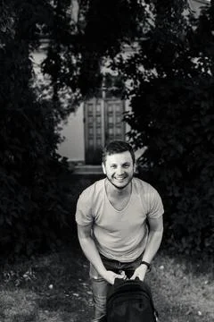A young man in the park with a backpack Stock Photos