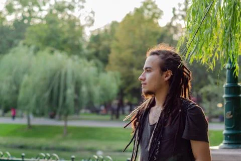 The young man is at the park. Stock Photos