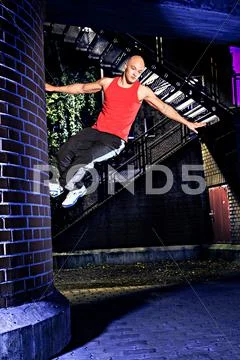 Young man at parkour training in the city Stock Photos