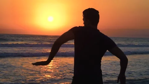 Young man partying on beach doing arm wave dance move Stock Footage 133374287