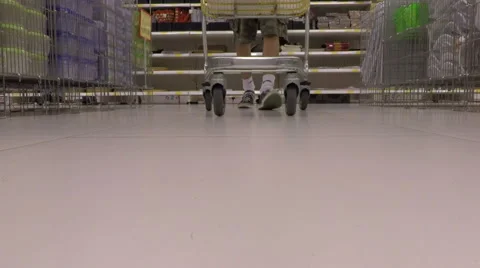 Young man pass over the camera with shopping cart in the store Stock Footage 54629789