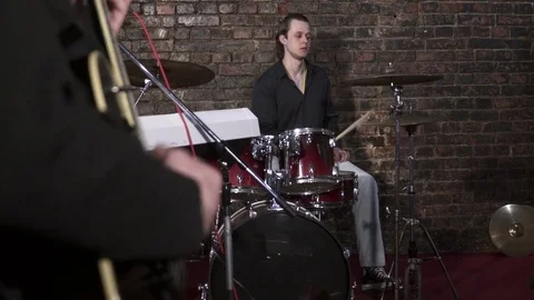 Young man paying on the drum kit on the rehearsal Stock Footage 74208541
