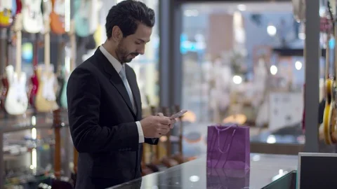 Young man paying with QR code by smartphone contactless Stock Footage 120437182