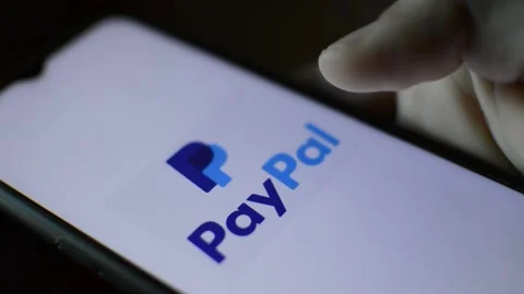 Young man with paypal logo on his smartphone. paypal bank app phone Stock Footage 187486558