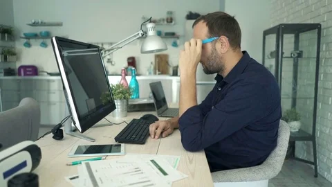 Young man with pc computer thinking, truing to solve problem at home Stockbeeldmateriaal 74959084