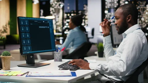 Young man PC user interacting with AI chat system on pc at office late at night Stock Footage 318500084