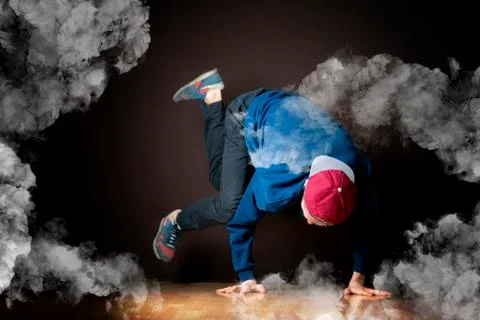 Young man perform break dance in smoked studio Stock Photos