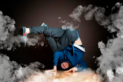 Young man perform break dance in smoked studio Stock Photos