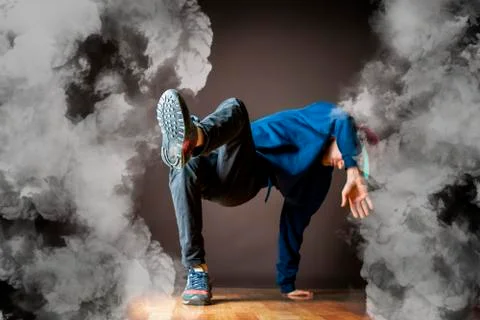 Young man perform break dance in smoked studio Stock Photos