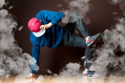 Young man perform break dance in smoked studio Stock Photos