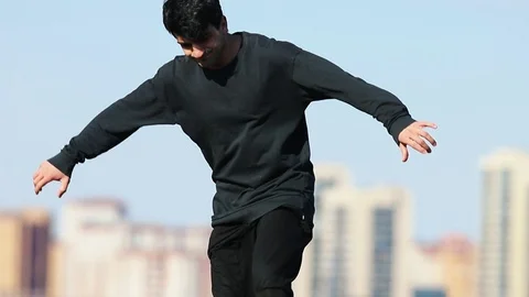 Young man performing acrobatic tricks in the air. Stock Footage 106859595