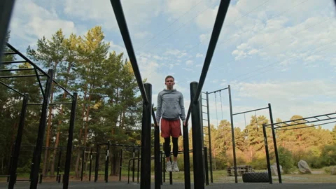 Young Man Performing Dips on Parallel Bars in Outdoor Gym Stock-Footage 315175374