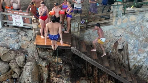Young Man Performing Frontflip Jump into Sea - Akyaka Turkey 16 Aug 2023 Stock Footage 329379366