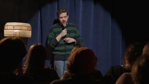 Young Man Performing Stand Up Comedy Monologue in Front of Audience Stock Footage 333227338