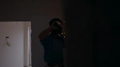 Young man performs electrical welding work in a new house Stock Footage 91834286