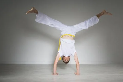 Young man performs a handstand, capoeira Stock Photos