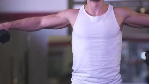 Young Man Performs Lateral Deltoid Raise in Mirror at Gym Stock Footage 85317569