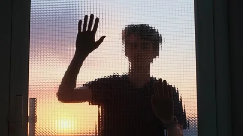 A young man persistently knocks on the door of a building Stock Footage 274361847