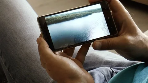 Young man with phone in hand Stock Footage 78306533