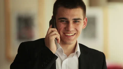 Young man with phone looking at the camera and smiling Video stock 22769785