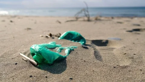 Young man pick up plastic garbage on sea coast,clean up ecosystem pollution,4k Stock Footage 120883225