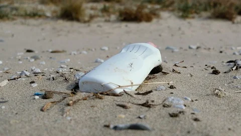 Young man pick up plastic garbage on sea shore,clean up ecosystem pollution,4k Stock Footage 120913333