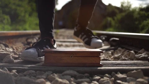 Young man picks up box of train tracks Stock Footage 124924014