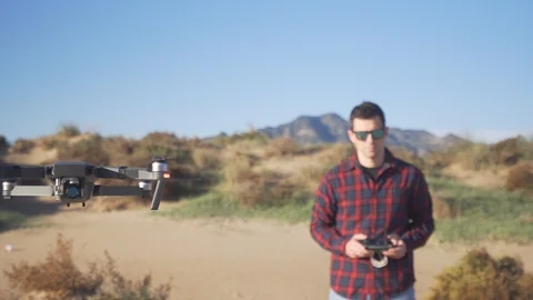 Young man piloting a drone Видео 98749552