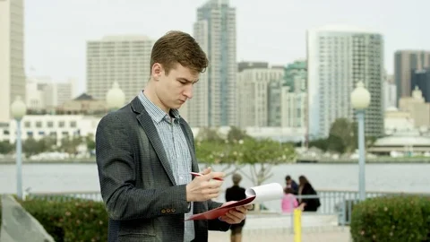 Young man with a plane table on a sidewalk Stock Footage 75670341