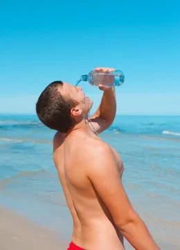 Young man with plastic bottle Fotos Stock