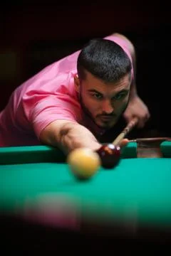 Young man playing billiard game at pub Stock Photos