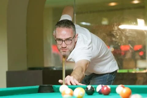 Young man playing billiard Stock Photos