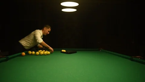Young man playing billiards in the dark billiard club Stock-Footage 120111017