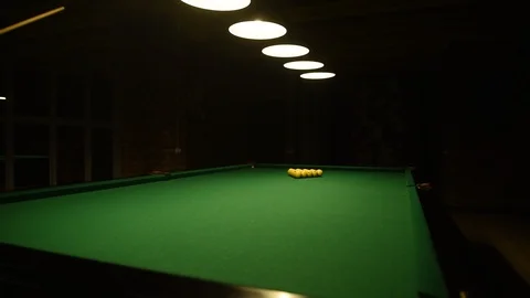 Young man playing billiards in the dark billiard club Stock Footage 120111024