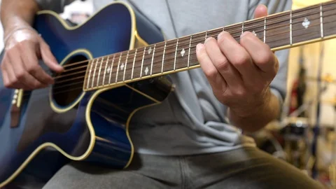Young man playing blue guitar at home during the Covid-19 quarantine. Stock Footage 128736215