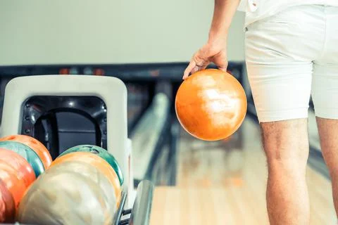 Young man playing bowling. Stock Photos