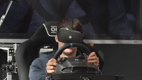 Young man playing a car racing game with virtual reality glasses closeup Video stock 104098547