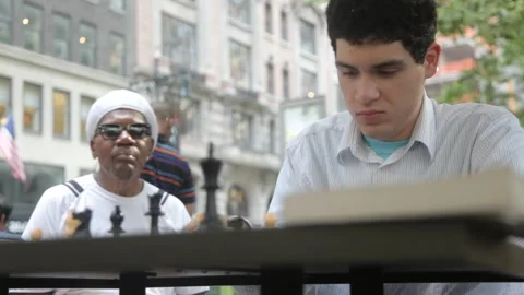 Young Man Playing Chess Outdoors with Opponent Stock Footage 341323804