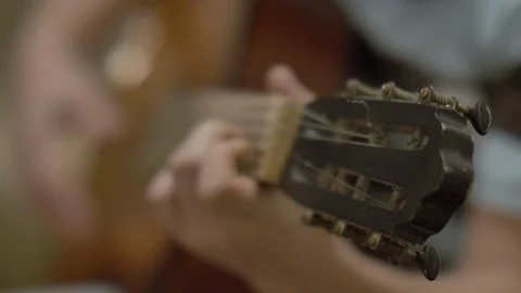 Young man playing a classical guitar Stock Footage 119451733