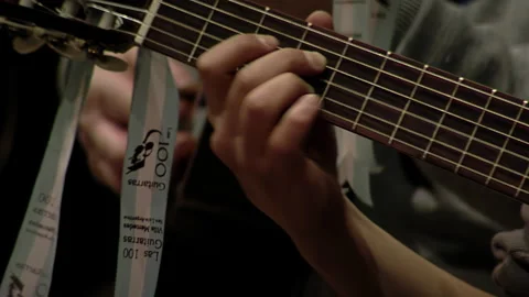 Young Man Playing a Classical Guitar Decorated with an Argentine Ribbon. 스톡 동영상 243049544