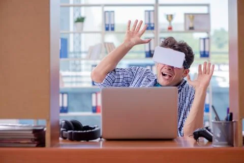 Young man playing computer game with virtual reality glasses Foto stock